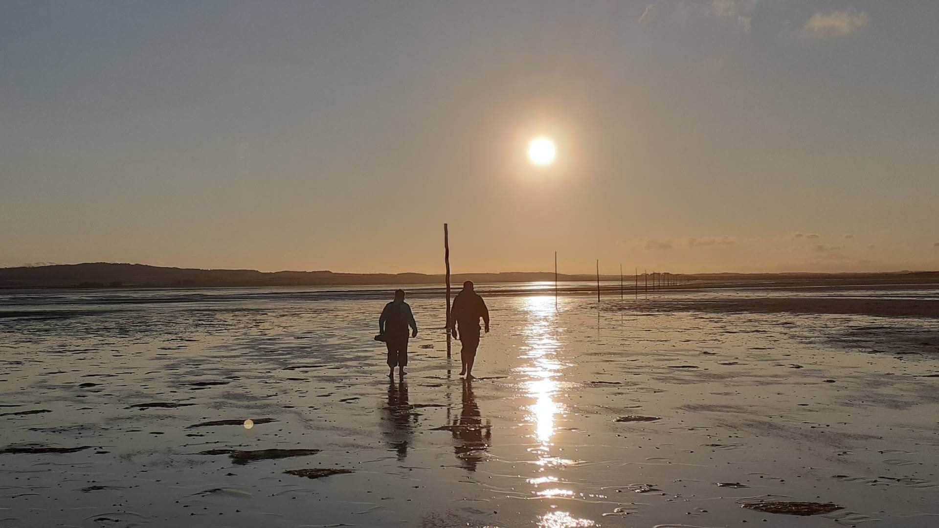 Couple walking in the sunset on the Pilgrim Way