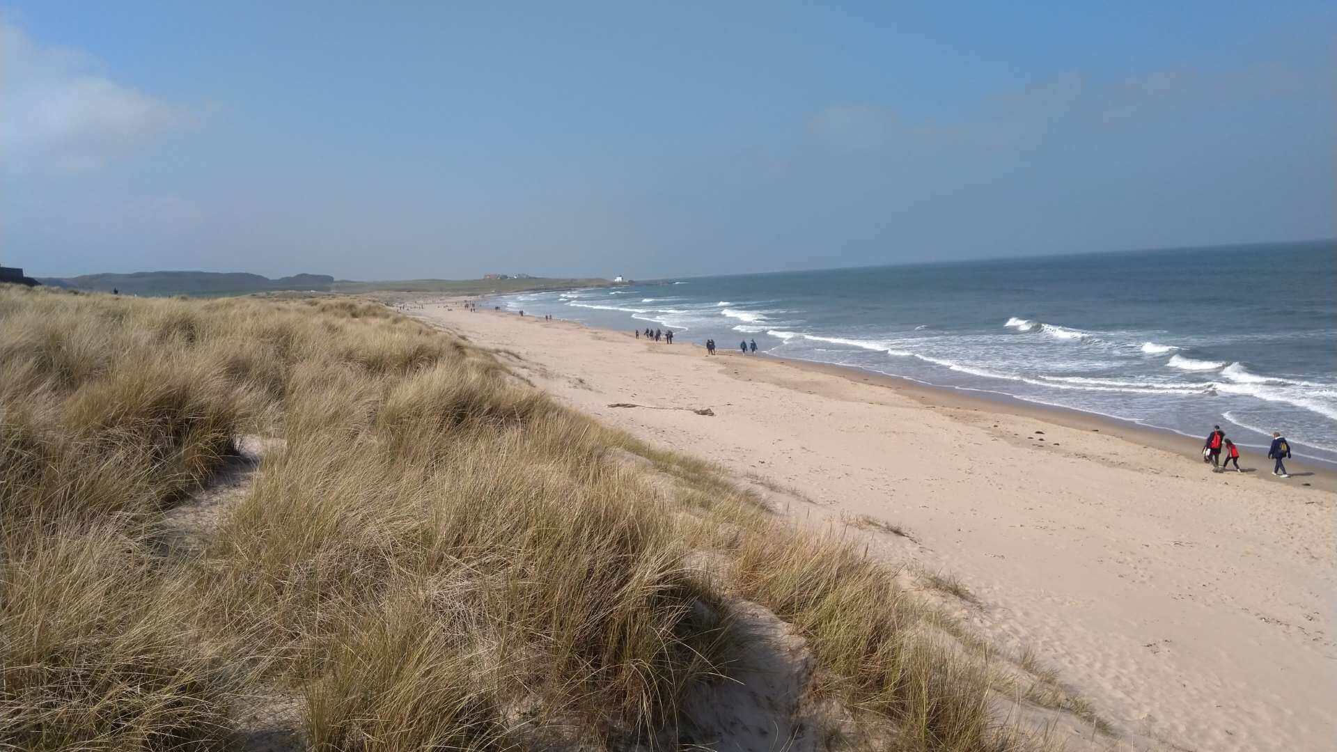 Walkers on Bamburgh Beach
