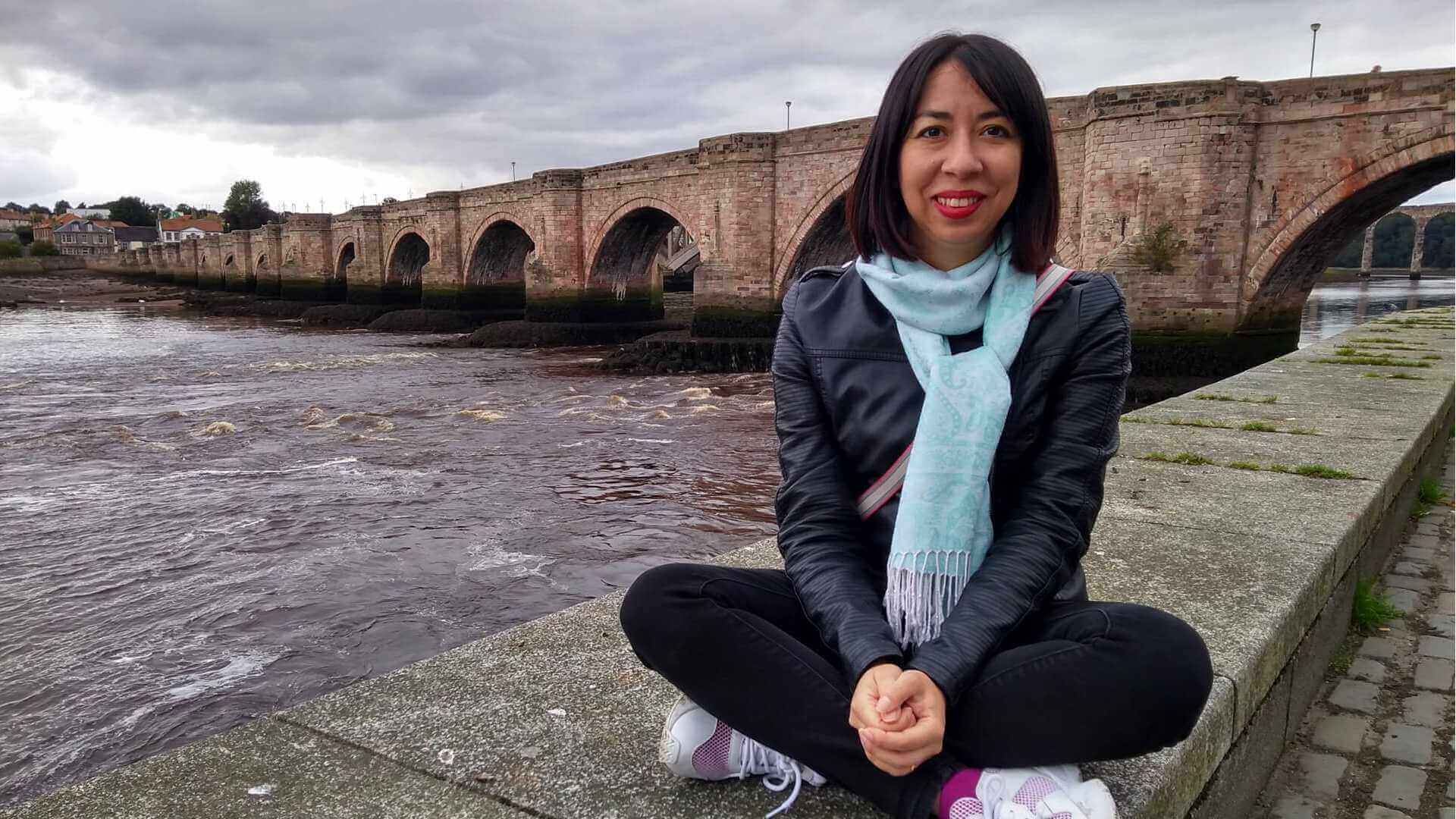 Women sat next to the River Tweed