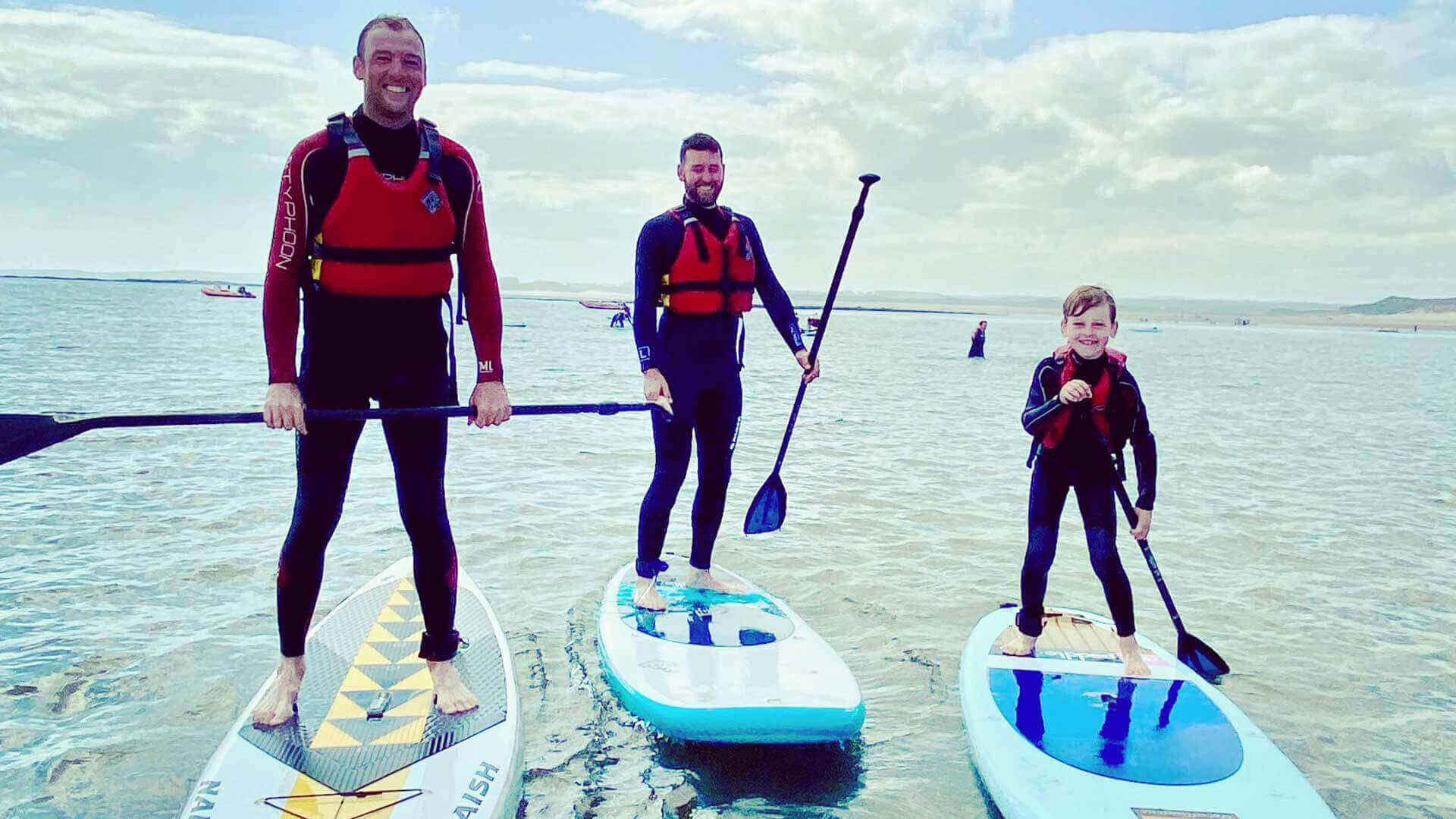 Family paddleboarding in Northumberland