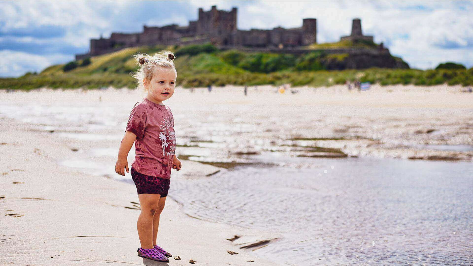 Little girl on Bamburgh beach